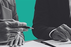 [ai] Two hands shown above documents on a table. The left hand holds a pen pointing while the right hand rests on the paper, with green background highlighting the scene.
